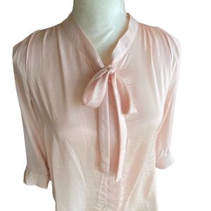 Pink blouse with tie at front.